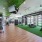 fitness center with turf, garage doors, weight lifting, and cardio equipment