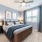 South Phoenix, AZ Apartments - Solara Vista - Bedroom with a Large Window, Wooden Wardrobe, and Carpeting