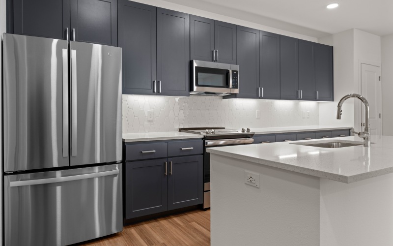 upscale finishes in one bedroom apartment with quartz countertops and stainless steel appliances