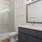 bathroom with shower and large mirror