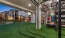 indoor/outdoor fitness space with artificial turf and exercise equipment  at solara vista south phoenix apartments for rent