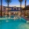Expansive Resort-Style Pool Surrounded By Lounge Seating and Large Palm Trees| Solara Vista Luxury Apartments in Phoenix, AZ 
