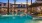 Expansive Resort-Style Pool Surrounded By Lounge Seating and Large Palm Trees| Solara Vista Luxury Apartments in Phoenix, AZ 